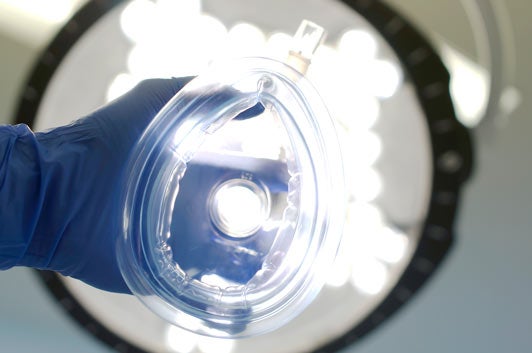 Oxygen mask in hand before surgery