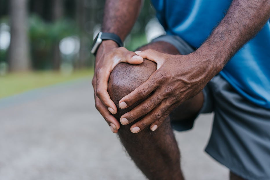 Male holding knee