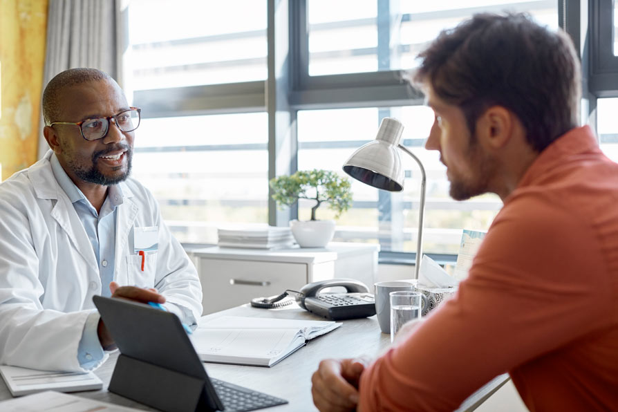 Man talking with doctor in office
